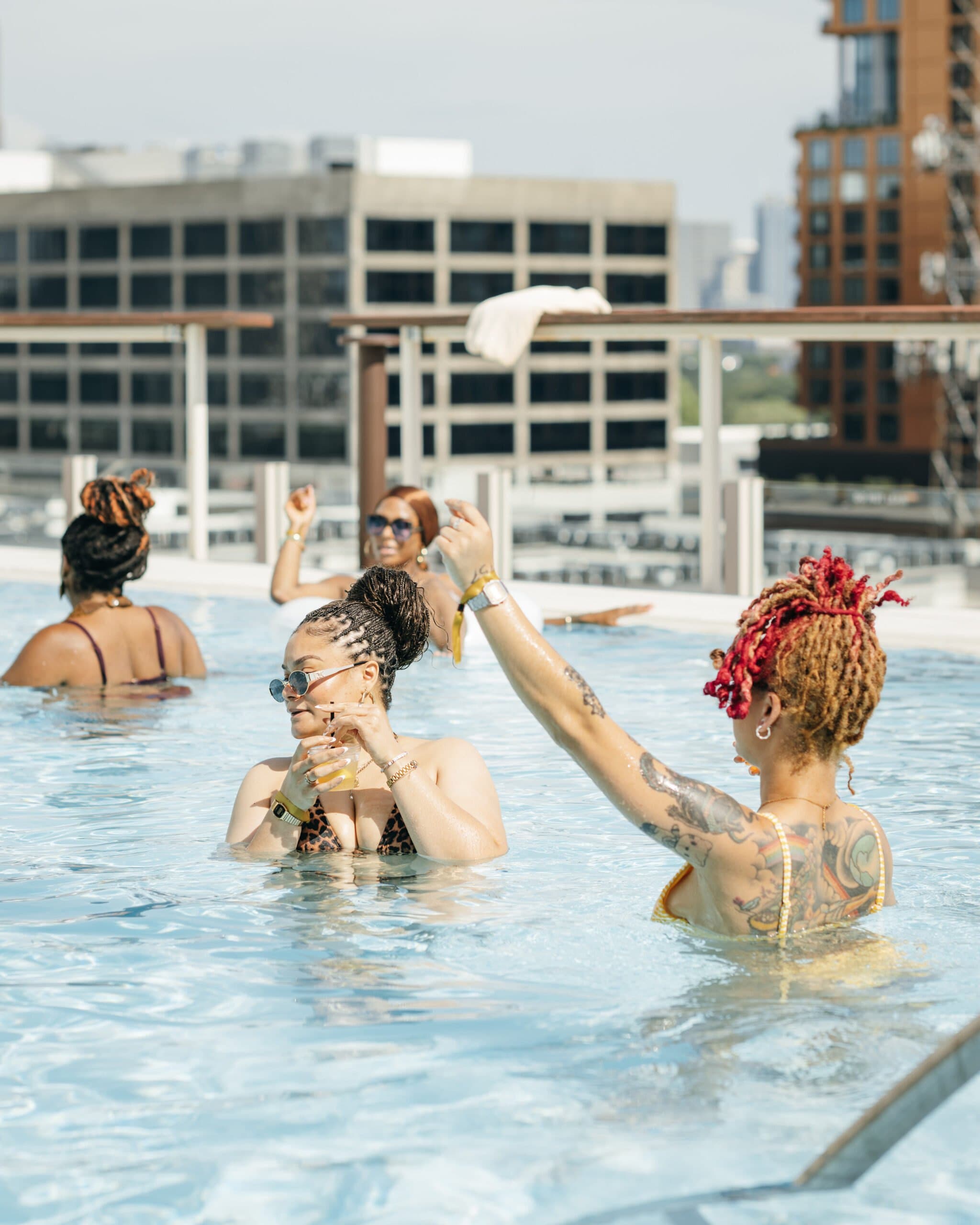 Members in the rooftop pool at Retreat by TGS