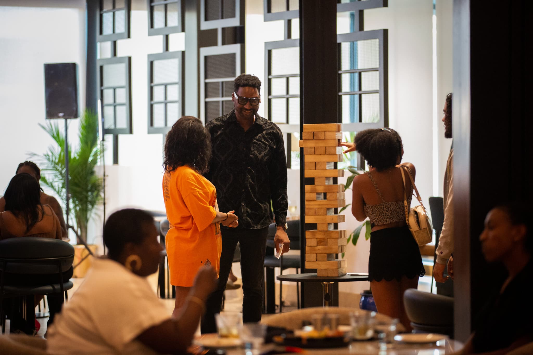 Members gathered around a Jenga game in the club